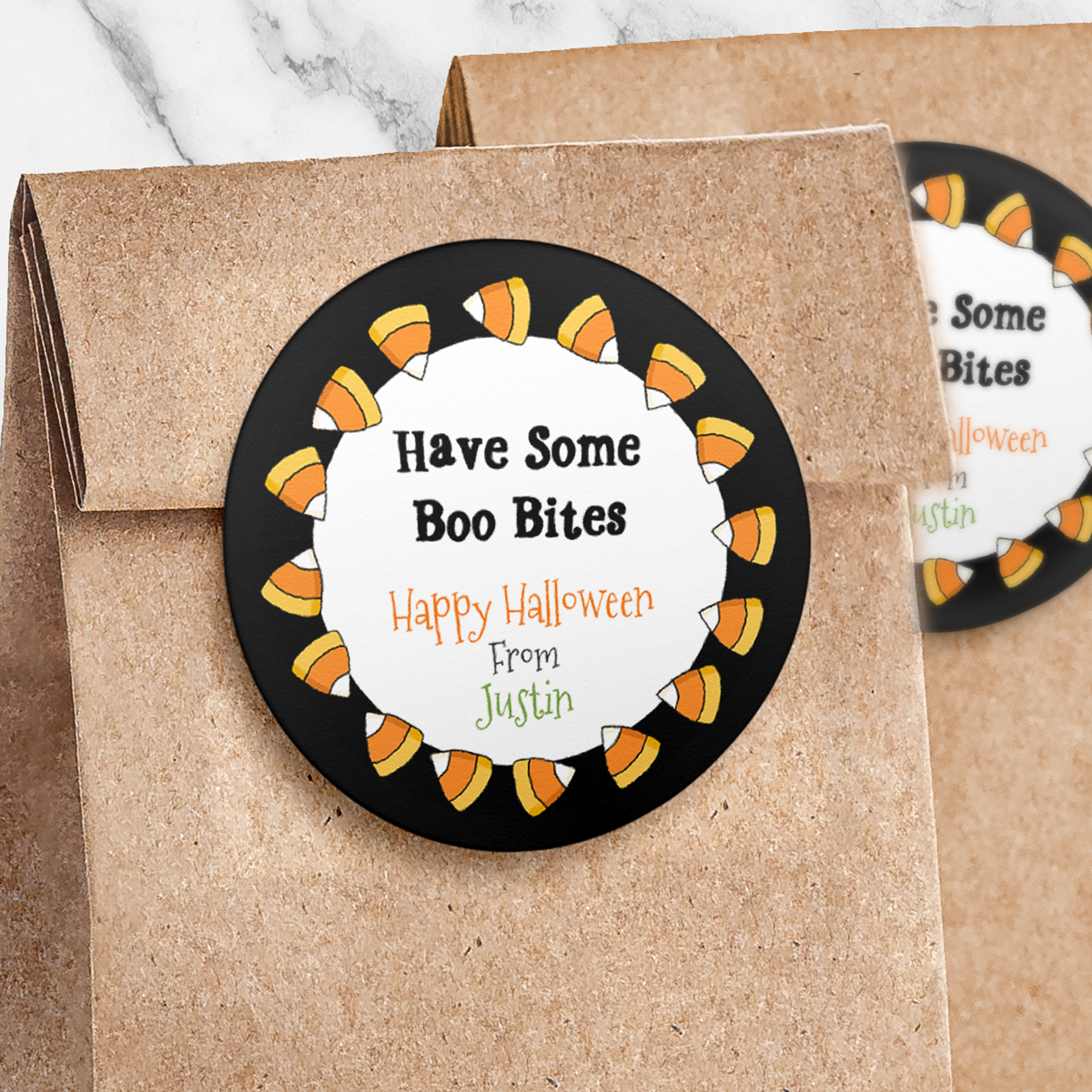 Round sticker with black colorul candy corn border on paper trick or treat bag