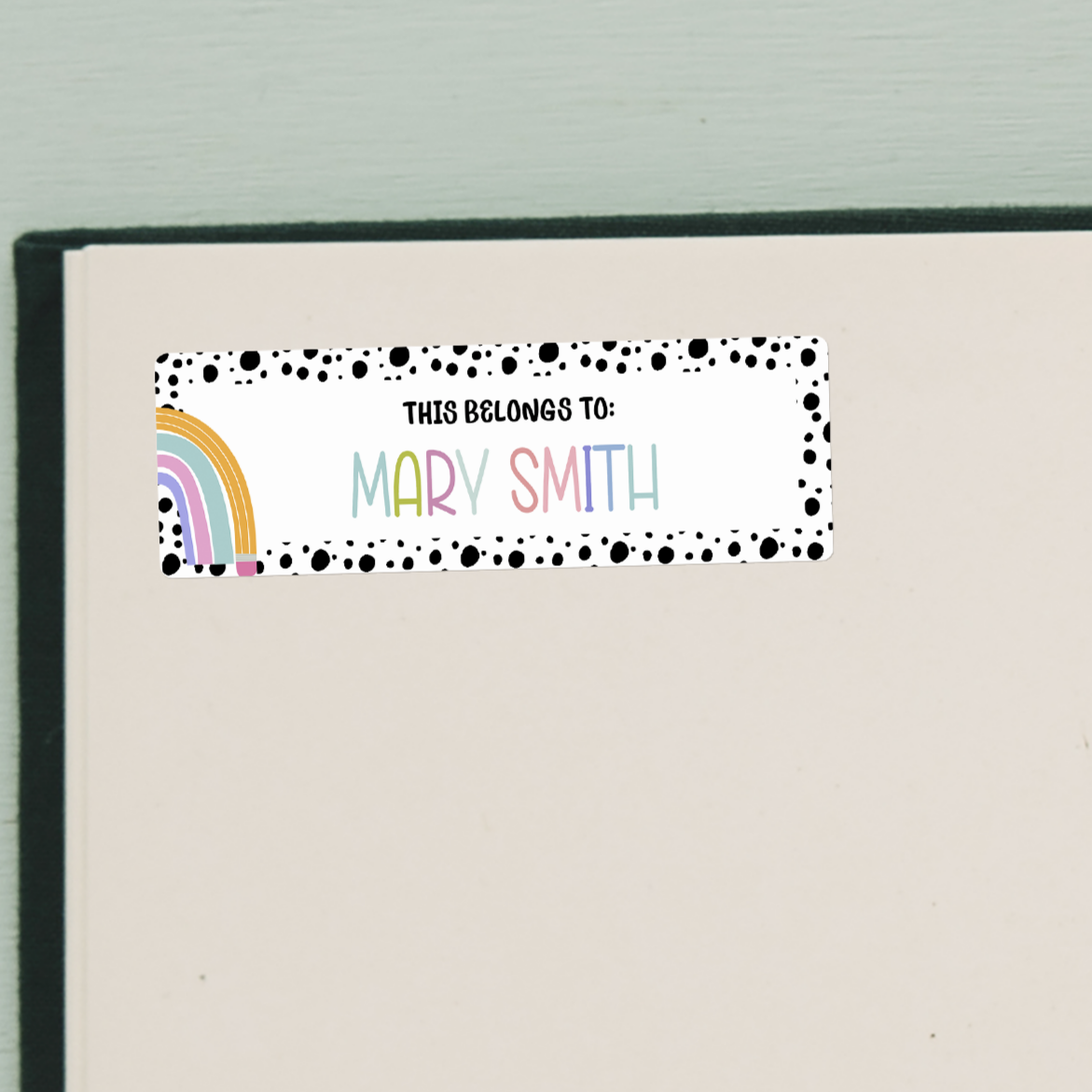 Rainbow Spotted Border Name Stickers on beige inside cover of book