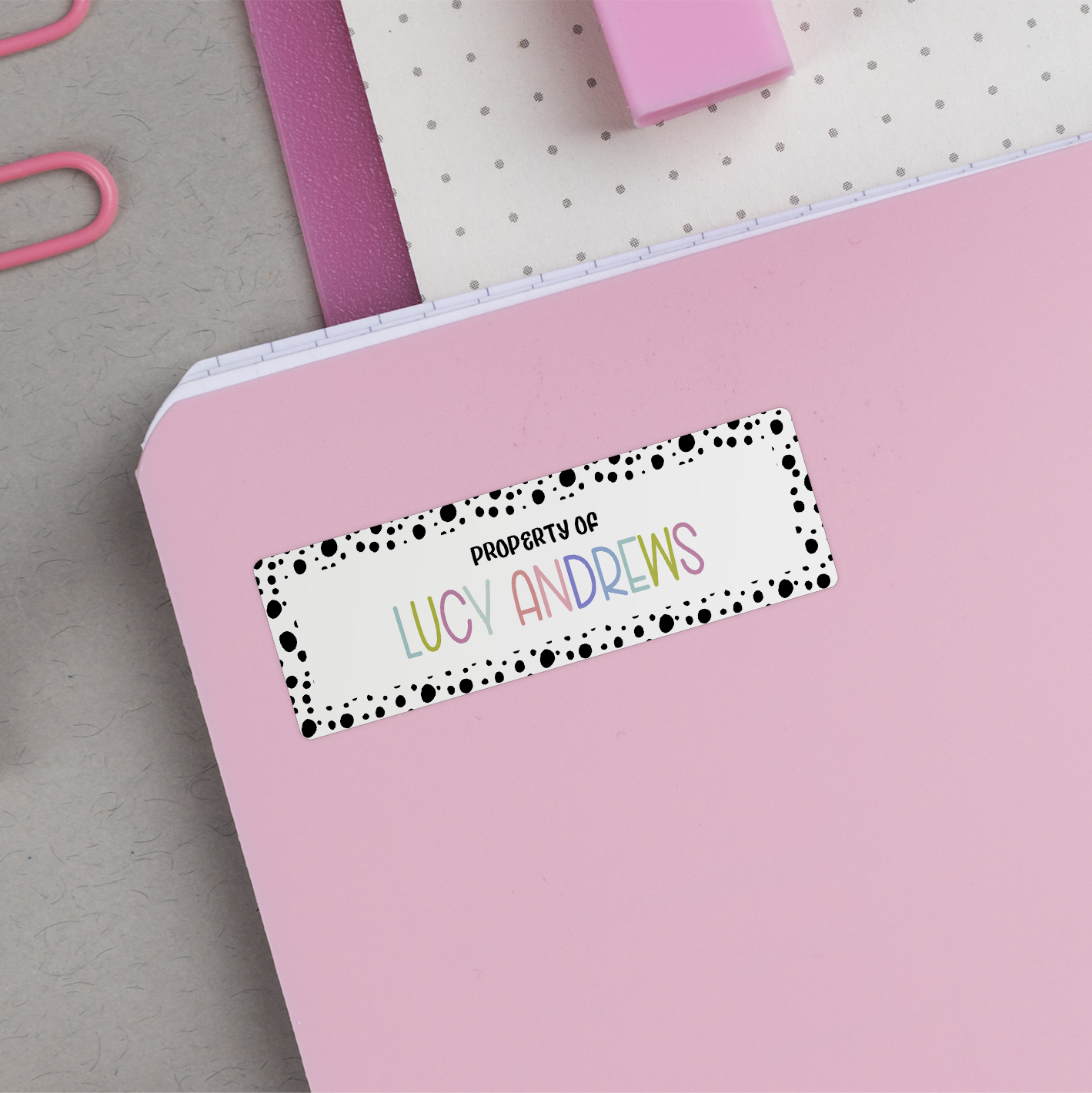 Spotted Border Name Stickers on back of pink notebook