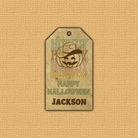 Halloween-themed tag with a pumpkin face and text on a beige background
