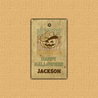 Vintage-style Halloween tag with cowboy design and text on a beige textured background