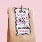 Halloween-themed gift tag with text and graphics on a pink background