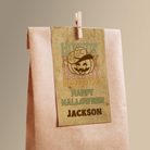 Kraft paper bag with a Halloween-themed label featuring a cowboy design and text.