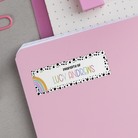 Rainbow Spotted Border Name Stickers on back of pink notebook